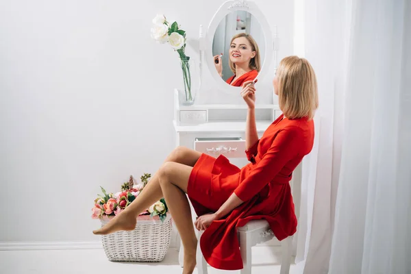 Fashion and business style. Perfect make-up. Sexy woman put on lipstick at mirror. Look of sexy girl or business lady with makeup. Beauty salon or boudoir. Trendy cosmetics and skincare. — Stock Photo, Image