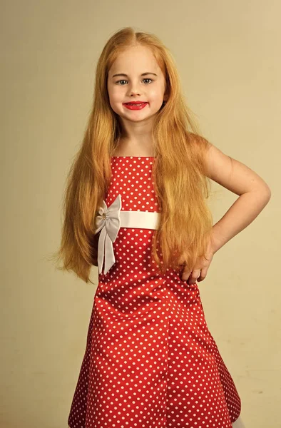 Kids face skin care. Portrait girl face in your advertisnent. Retro look and hairdresser, makeup. retro girl in red dress