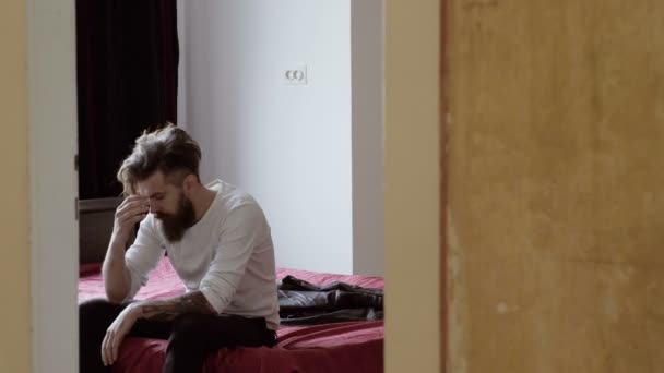 Tired man resting on bed in room — Stock Video