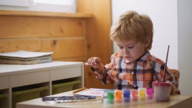 Erken çocukluk eğitimi, resim, yetenek, mutlu bir aile ve ebeveynlik kavramı. Şirin, ciddi ve odaklanmış çocuk çizim.