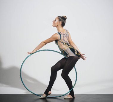 esmer kız hoola hoop gri arka plan üzerinde egzersiz