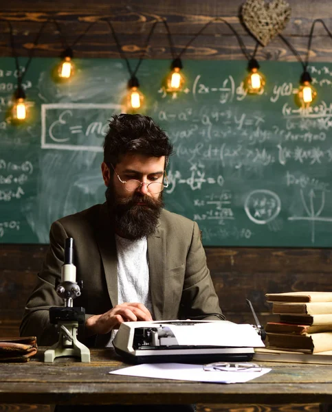 Bearded man type on vintage typewriter. Man with beard typewrite research paper. Businessman in suit work at desk. Scientist in glasses with microscope and books. Future and archaism — Stock Photo, Image
