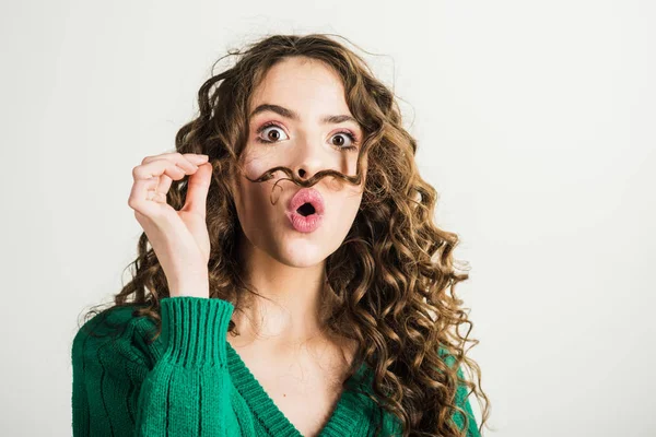 Beyaz arka plan üzerinde uzun kıvırcık saçlı sevimli kız portresi.