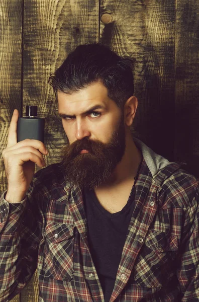 Male cologne. man posing with black perfume or cologne bottle — Stock Photo, Image