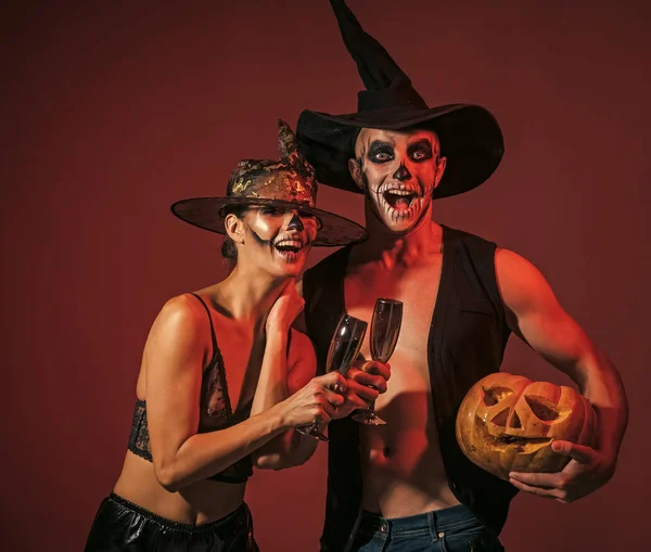 Happy Halloween. Halloween couple with makeup on brown background.
