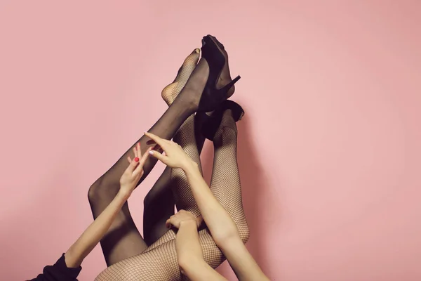 Confusion. sexy legs of girls in fashionable tights and shoes — Stock Photo, Image