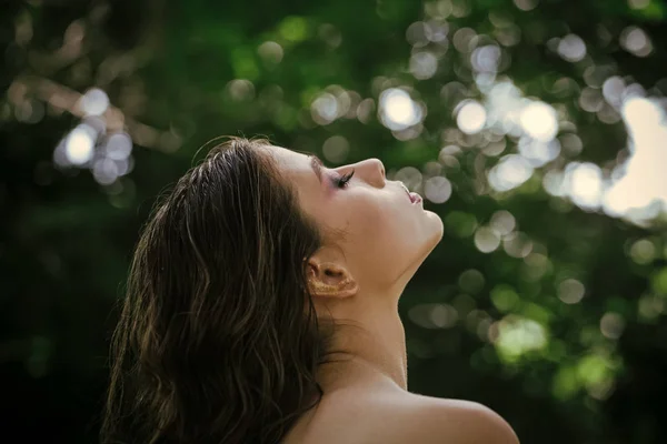 Cuidado del cabello, terapia y tratamiento. Mujer con peinado rizado y hombro desnudo en el día de verano. Mujer con el pelo largo morena en la naturaleza. Chica con cara de maquillaje, belleza. Modelo de moda con look glamour —  Fotos de Stock