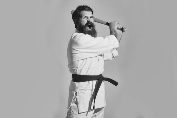 Inept karate. bearded shouting karate man in kimono with green baseball bat — Stock Photo, Image