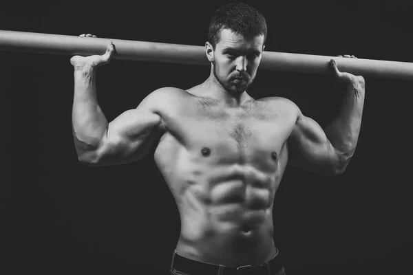 Hombre musculoso y brutal. Hombre muscular con travesaño — Foto de Stock