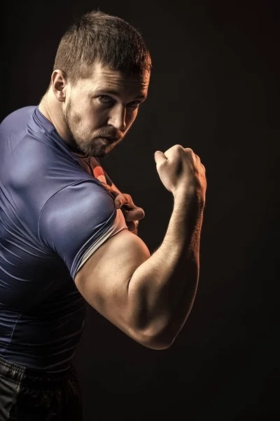 muscular brutal man. Man showing biceps