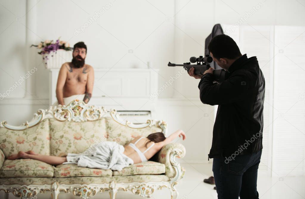 Husband with weapon shoot cheating wife and lover. Man with gun aim at blur couple in bedroom. Killer hold sniper rifle in leather coat and jeans. Love triangle concept. Cheating, jealousy and crime