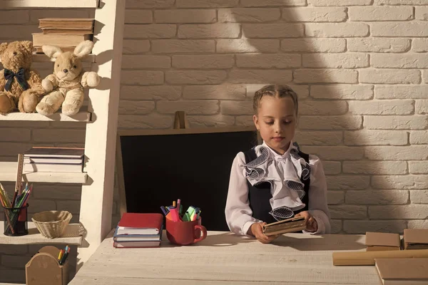 Okul için hazırlık. Geri okul ve eğitim kavramı. Kız masa başında oturur