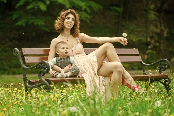 Mother with child. Woman and child relaxing on summer day on natural background