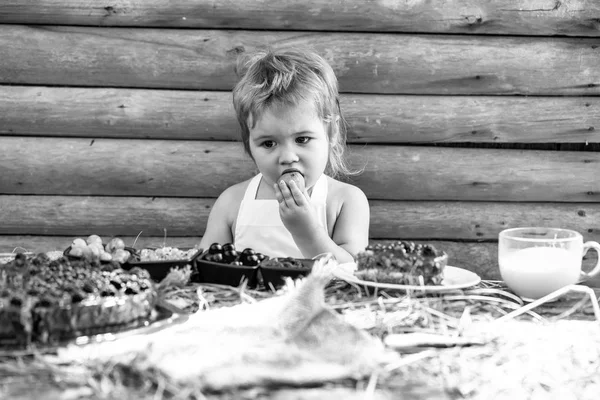 küçük çocuk yeşil elma yiyor.