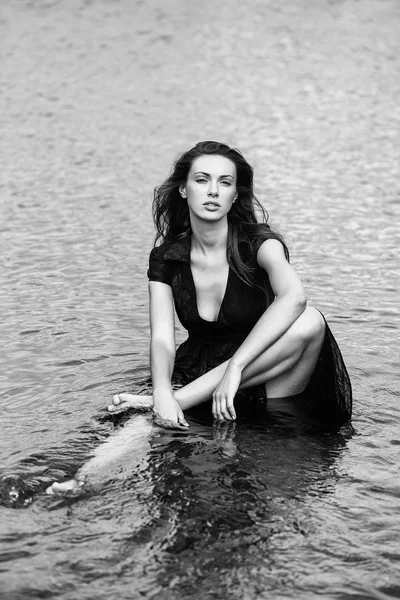 young sexy woman sitting in water