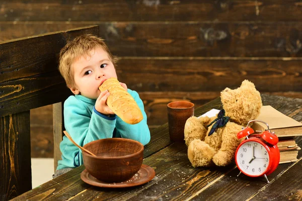 Dieta y comida. Dieta, niño pequeño come baguette francesa en la mesa. La dieta cura más que los médicos. Dieta saludable para niños — Foto de Stock