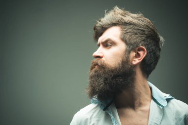Man brutal bearded hipster side view, copy space. How grow great beard. Ways optimize facial hair. Beard grooming has never been so easy. Beard care tricks will keep facial hair looking resplendent clipart