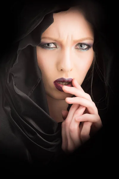 Sensual girl in black hood. girl with fashionable makeup Stock Picture