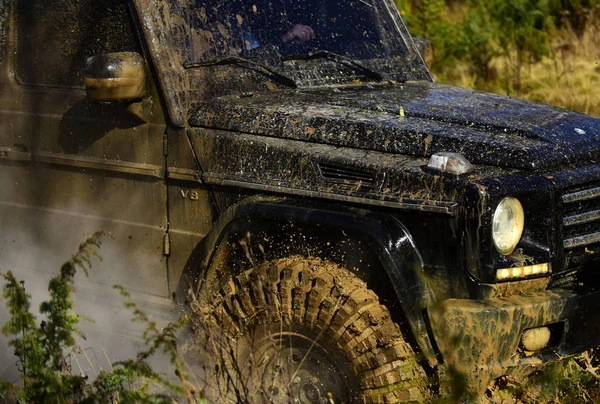 SUV borított szennyeződés jellegű háttér. Autó- és felhő füst része. Jármű csupa sár. Off road versenyzés, erő és extrém szórakozás koncepció — Stock Fotó