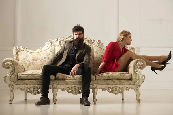 luxury concept. luxury couple rest on sofa. luxury life of sexy business woman and bearded man. couple relax on luxury sofa. enjoying time at home