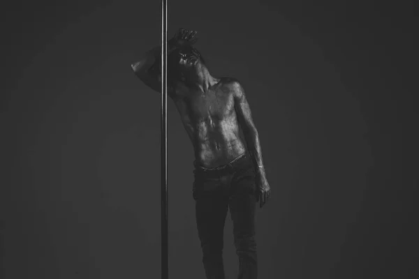 Tired dancer concept. Guy lean on metallic pole.