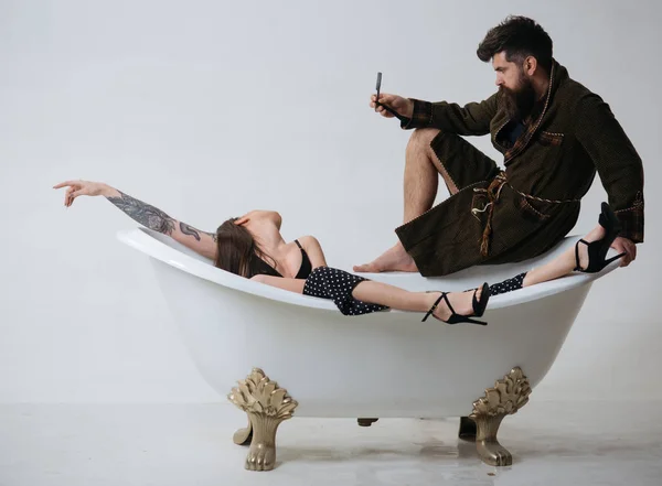 Salon concept. Bearded man and woman relax in bath, spa salon. Beauty salon. A hair salon that cares about you