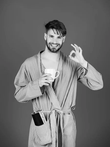 Χαλαρώστε χαμογελαστό άνθρωπο στο μπουρνούζι κρατώντας το φλιτζάνι του καφέ — Φωτογραφία Αρχείου