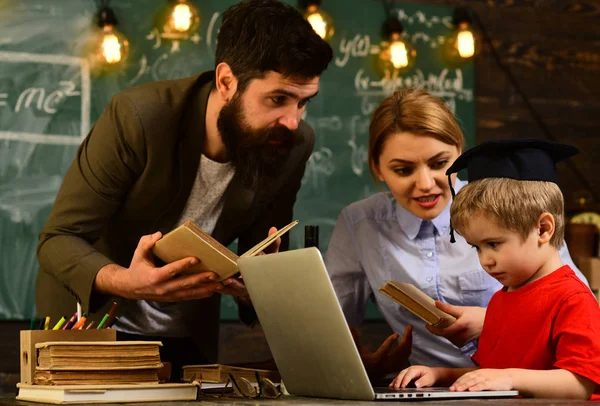 Happy teacher in classroom, Teacher puts marks sends feedback on email with laptop computer, Tutor sitting beside desk during private lessons at home, Student studying online courses with computer , — стоковое фото