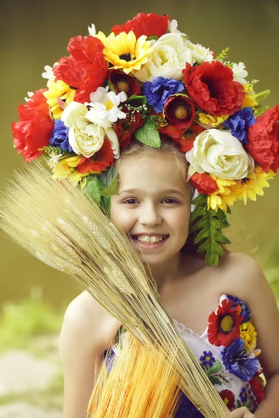 Mała dziewczynka w embriodered sukienka i kwiat krajowych wieniec — Zdjęcie stockowe