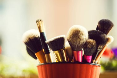professional brush for fashionable makeup or cosmetic in pink cup clipart