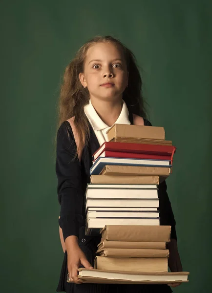 Kid with ponytails and plenty of textbooks for school — Stock Photo, Image