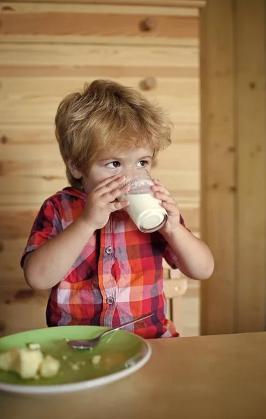 Küçük çocuk çocuk yemek muz ve içecek süt. — Stok fotoğraf