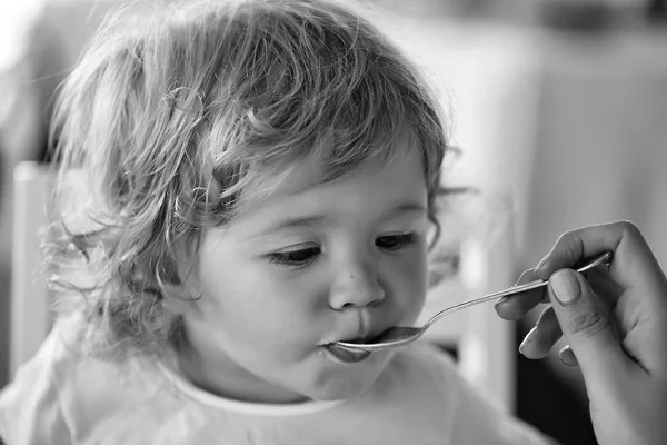 Baby boy fed with spoon — Stock Photo, Image