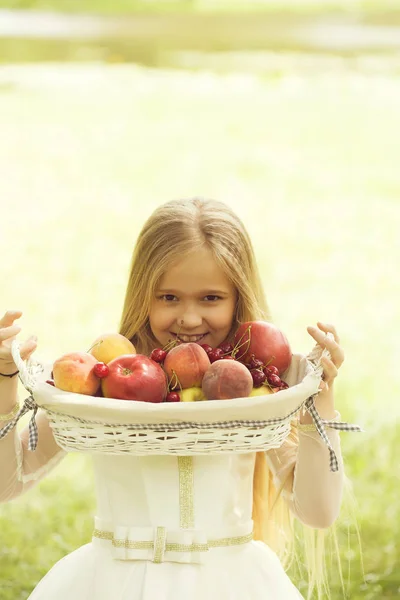 Small girl in dress with fruit basket — Stock Photo, Image