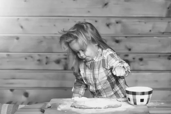 Niedliche Kind Kochen mit Teig, Mehl und Schüssel auf Holz — Stockfoto