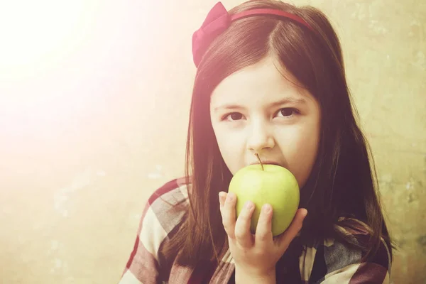 Pretty girl eating vitamin yellow apple Stock Picture
