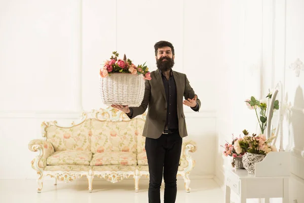 Florist concept. Happy florist man hold basket with fresh flowers. Florist salon. Florist in flower shop. Make someone happy