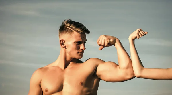 Bodybuilder met sterke hand biceps, triceps wedstrijd met vrouwelijke hand — Stockfoto
