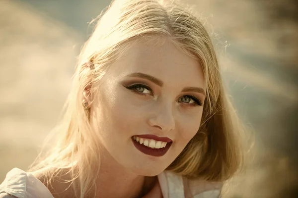 Happy woman with white smile on makeup face