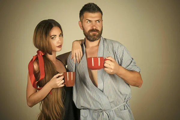 family of man and woman with red milk cup.