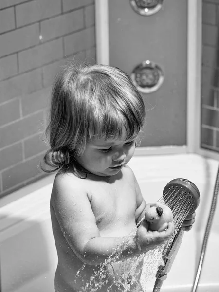 Boy with duckling in bath — Stock Photo, Image