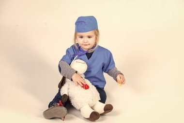 Doktor veteriner oyuncak hayvan ile oynarken tek tip çocuk