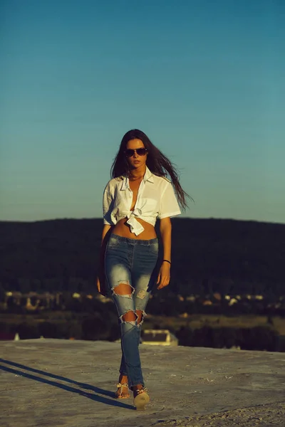 Bella ragazza che cammina sulla cima della montagna sul sole, cielo blu — Foto Stock