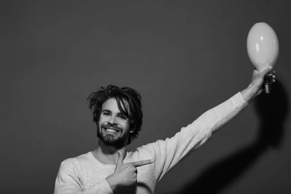 Man smiling with big lamp