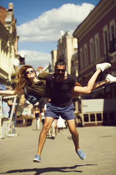 Gelukkig bebaarde man springen met sexy vrouw achterop — Stockfoto