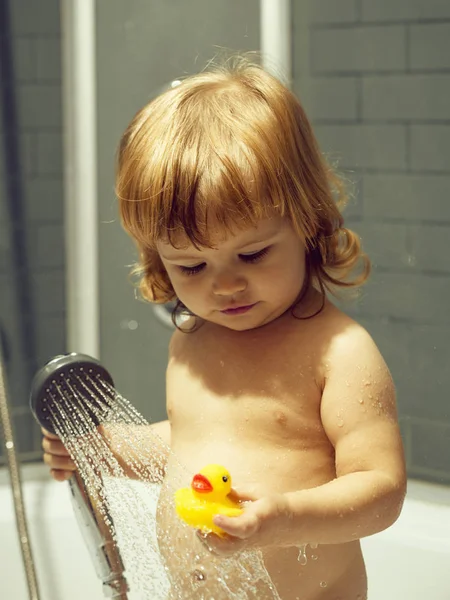 Boy with duckling in bath — Stock Photo, Image