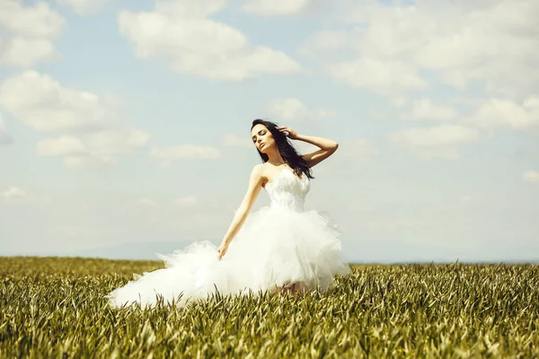 Pretty wedding girl on green grass and sky — Stock Photo, Image