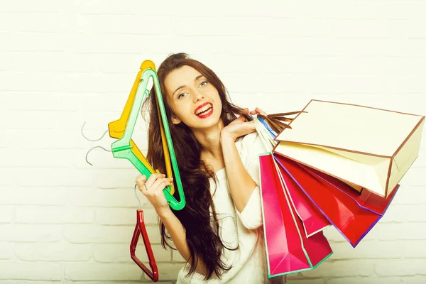 Femme avec sacs à provisions et cintres — Photo