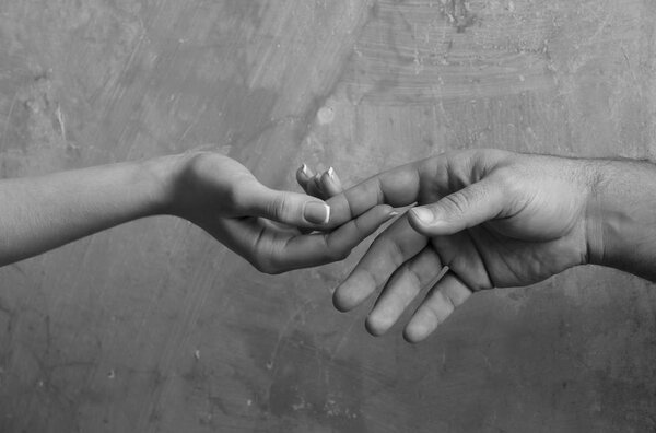 Male and female hands touching each other
