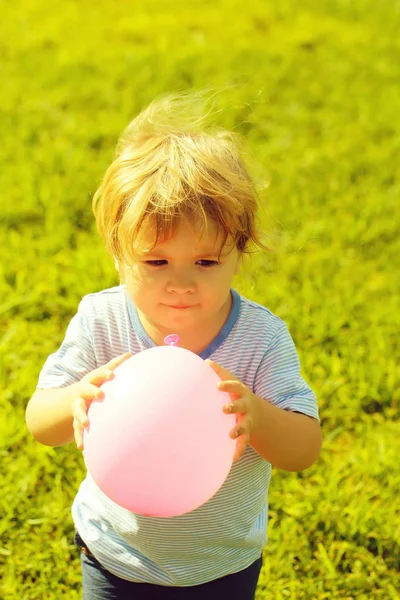 Chłopiec dziecko bawi się zabawkami różowy balon — Zdjęcie stockowe